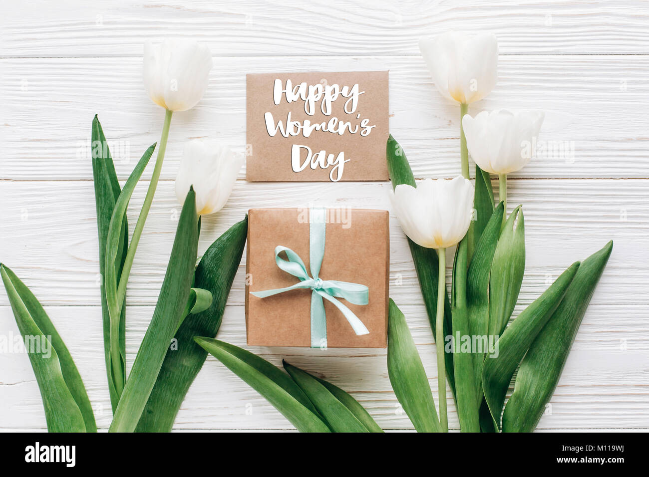 happy womens day text sign on greeting card with stylish present box ...