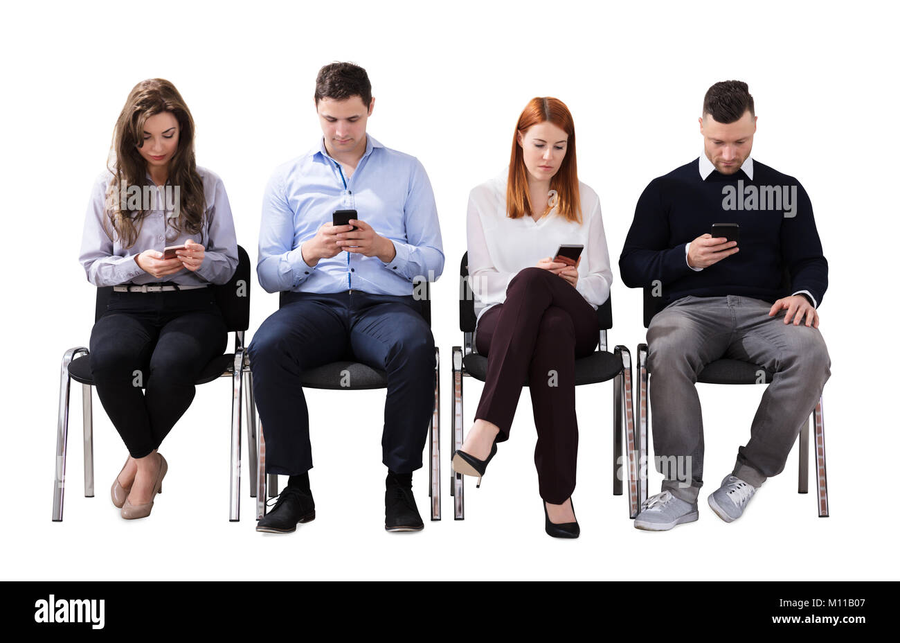 Group Of Multi Ethnic Business People Sitting On Chair Using Cell Phone  Against White Background Stock Photo - Alamy