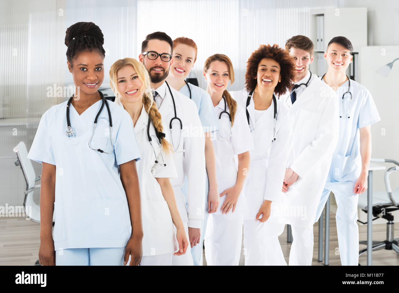 Portrait Of Confident Smiling Multi Ethnic Male And Female Doctors In Clinic Stock Photo