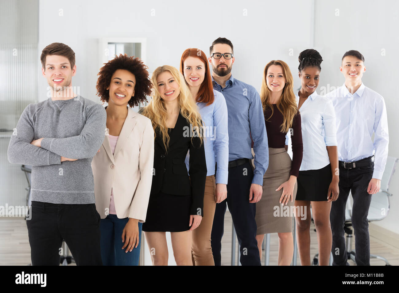 Confident Smiling Young Multi Ethnic Business People In Office Stock ...