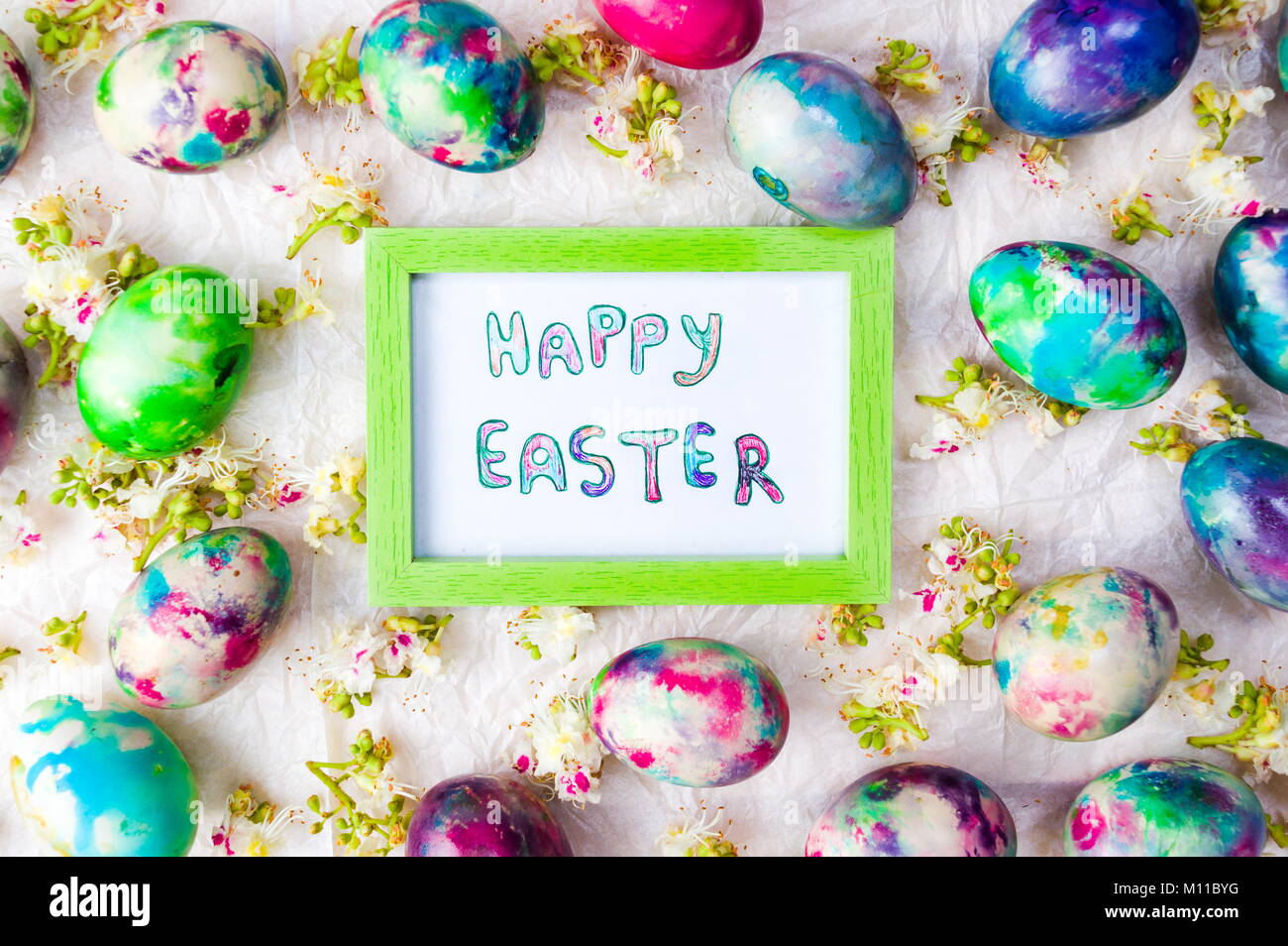 Easter eggs card and spring flowers background flat lay Stock Photo - Alamy