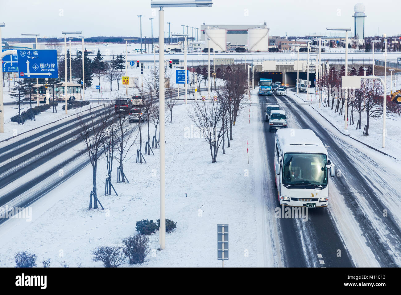 Hokkaido, Japan - 27 December 2017 - Vehicals travel on road at Chitose International Airport coverred with snow during winter in Hokkaido, Japan on D Stock Photo