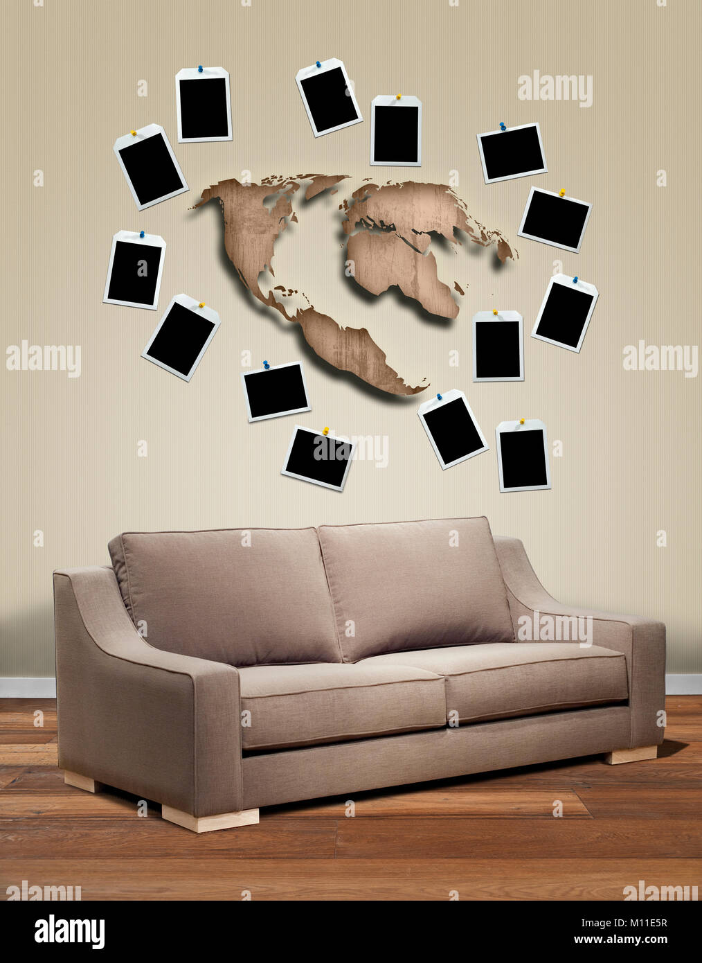 Modern interior with sofa and metal cartography of the world. Souvenir in frame at the wall Stock Photo