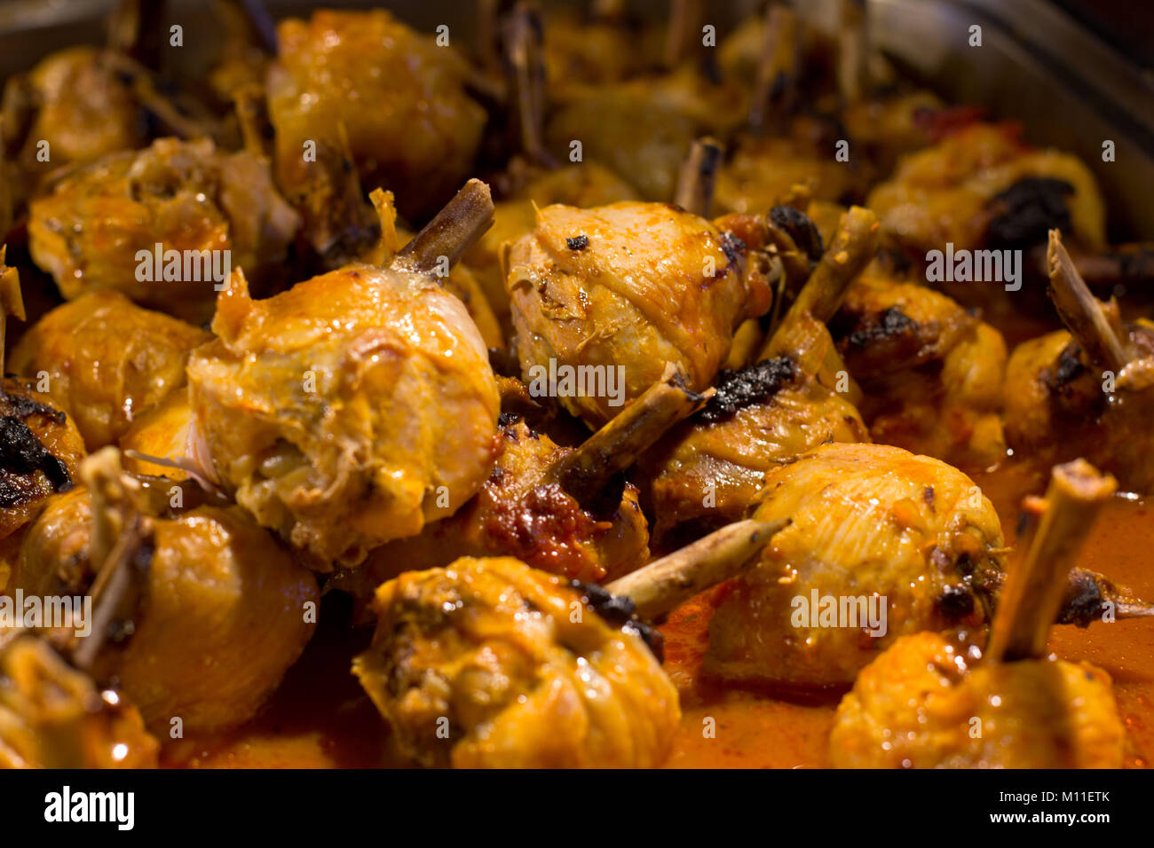 Chicken legs in a sauce, baked on grill Stock Photo