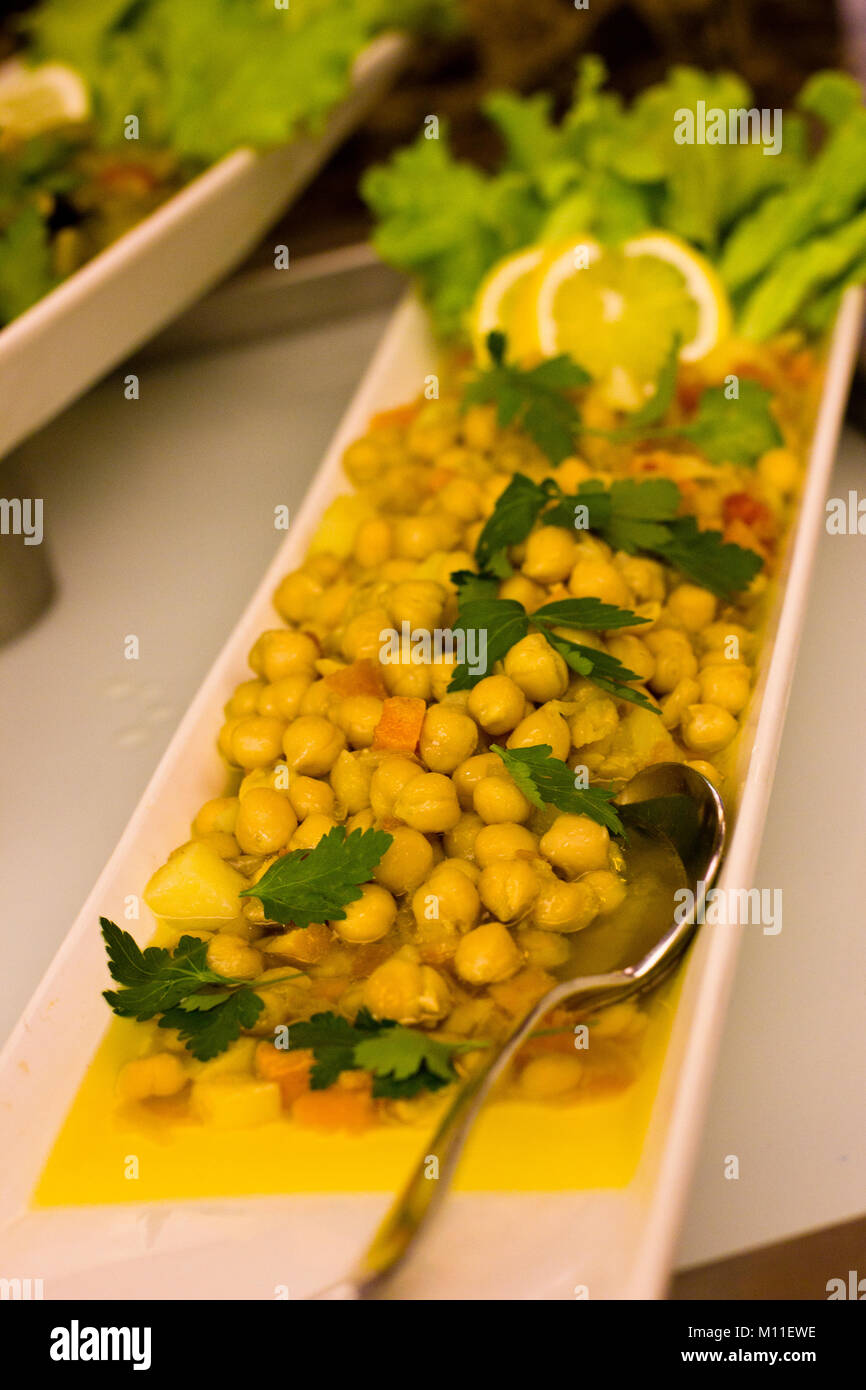 Boiled Turkish peas on white dish, decorated with parsley Stock Photo