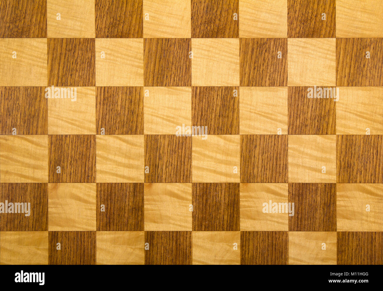 Old wooden chess board chequer pattern Stock Photo