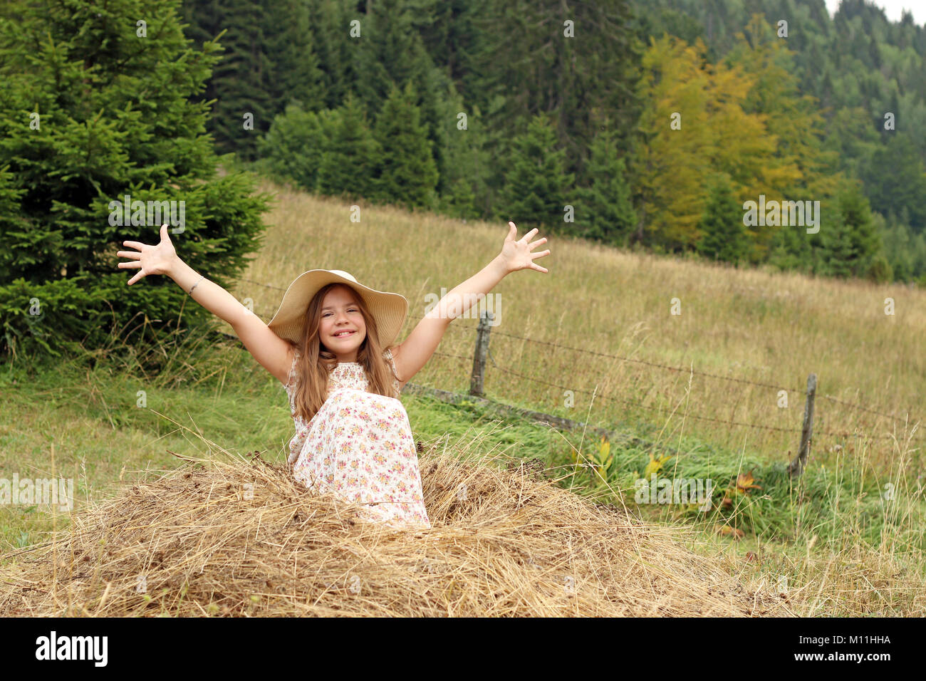 beautiful little girl with hands up enjoys nature summer season Stock ...