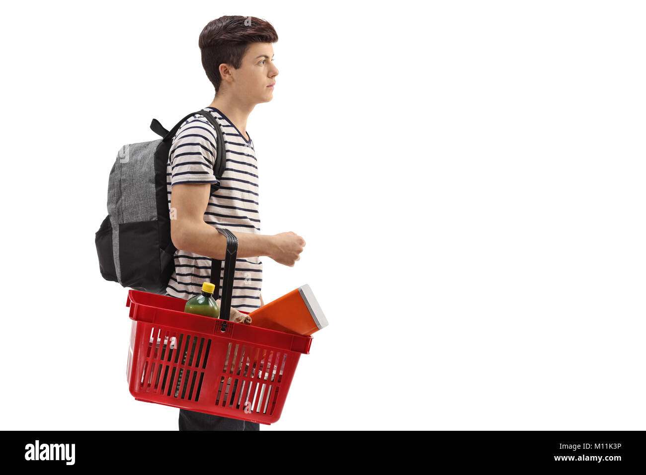 Teenage boy with a backpack and a shopping basket isolated on white background Stock Photo Alamy