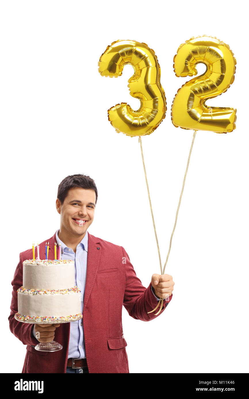 Elegantly dressed man holding a birthday cake and a number thirty-two shaped balloon isolated on white background Stock Photo