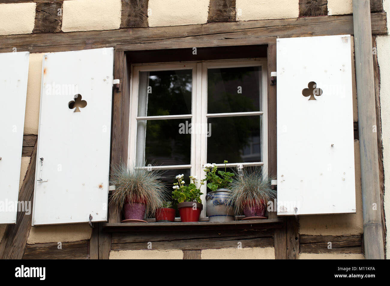 White window with shutters and flower pots Stock Photo - Alamy