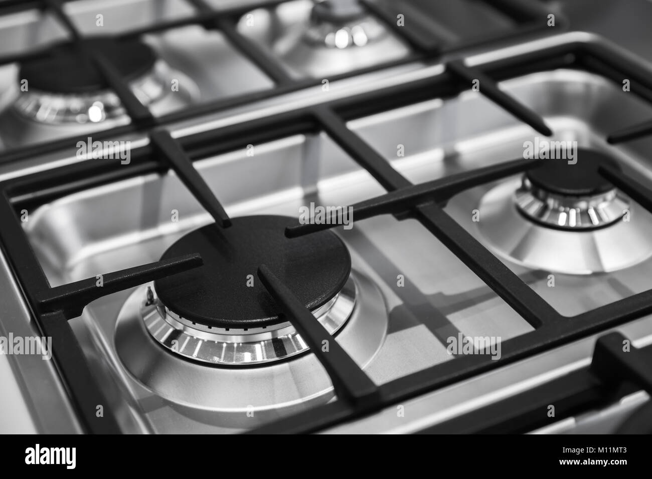 Modern gas stove burners made of shiny stainless steel and cast iron Stock Photo