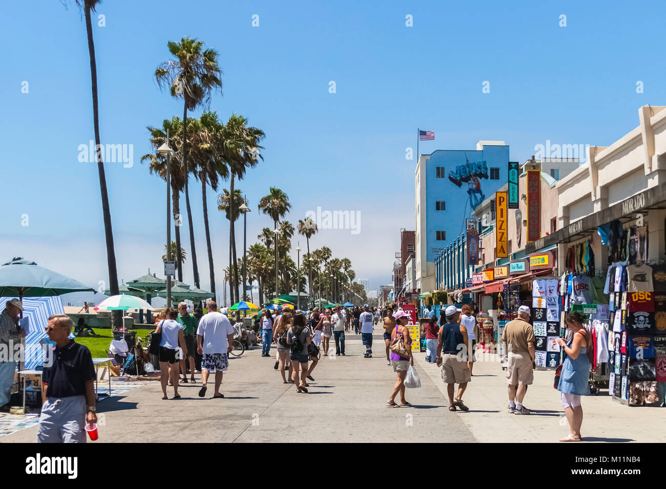 The crowded boardwalk of Venice Beach in Los Angeles during a sunny and ...