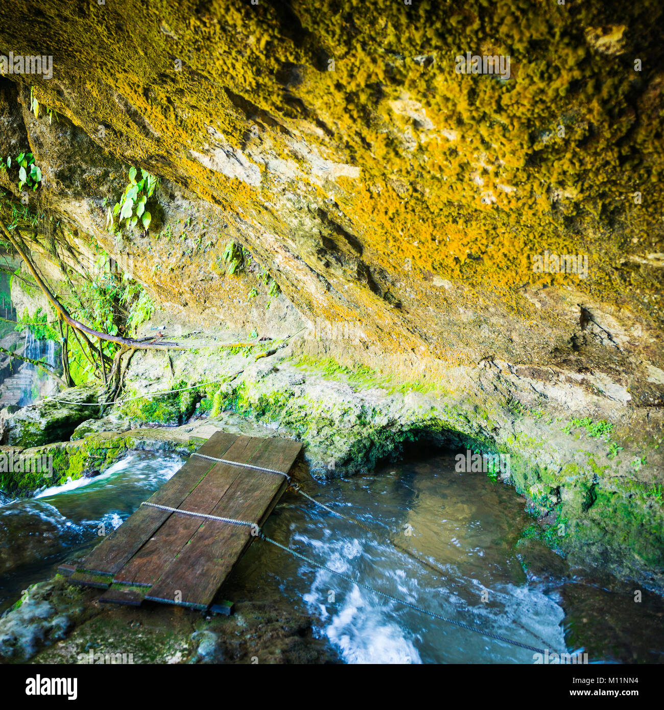 Cave bridge over river at Misol Ha Waterfall near Palenque in Chiapas, Mexico Stock Photo