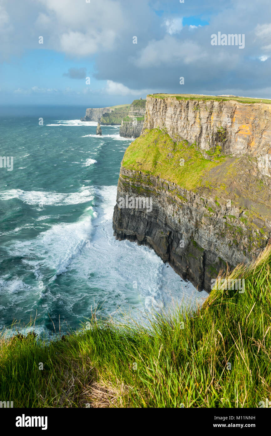 The Cliffs of Moher, Irelands Most Visited Natural Tourist Attraction, are sea cliffs located at the southwestern edge of the Burren region in County  Stock Photo