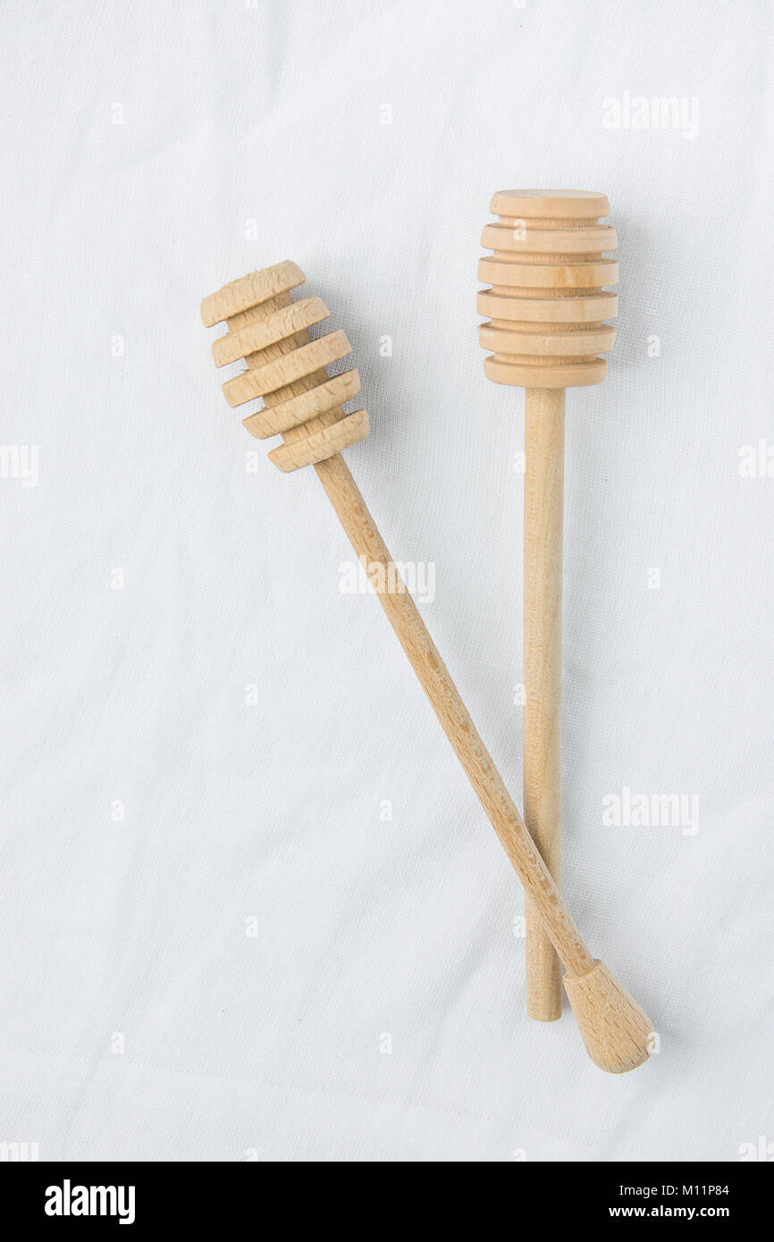 Two Wooden Honey Dippers Spoon on White Linen Fabric Background Table. Holiday Baking Cooking Workshop Course Announcement Template. Christmas Easter. Stock Photo