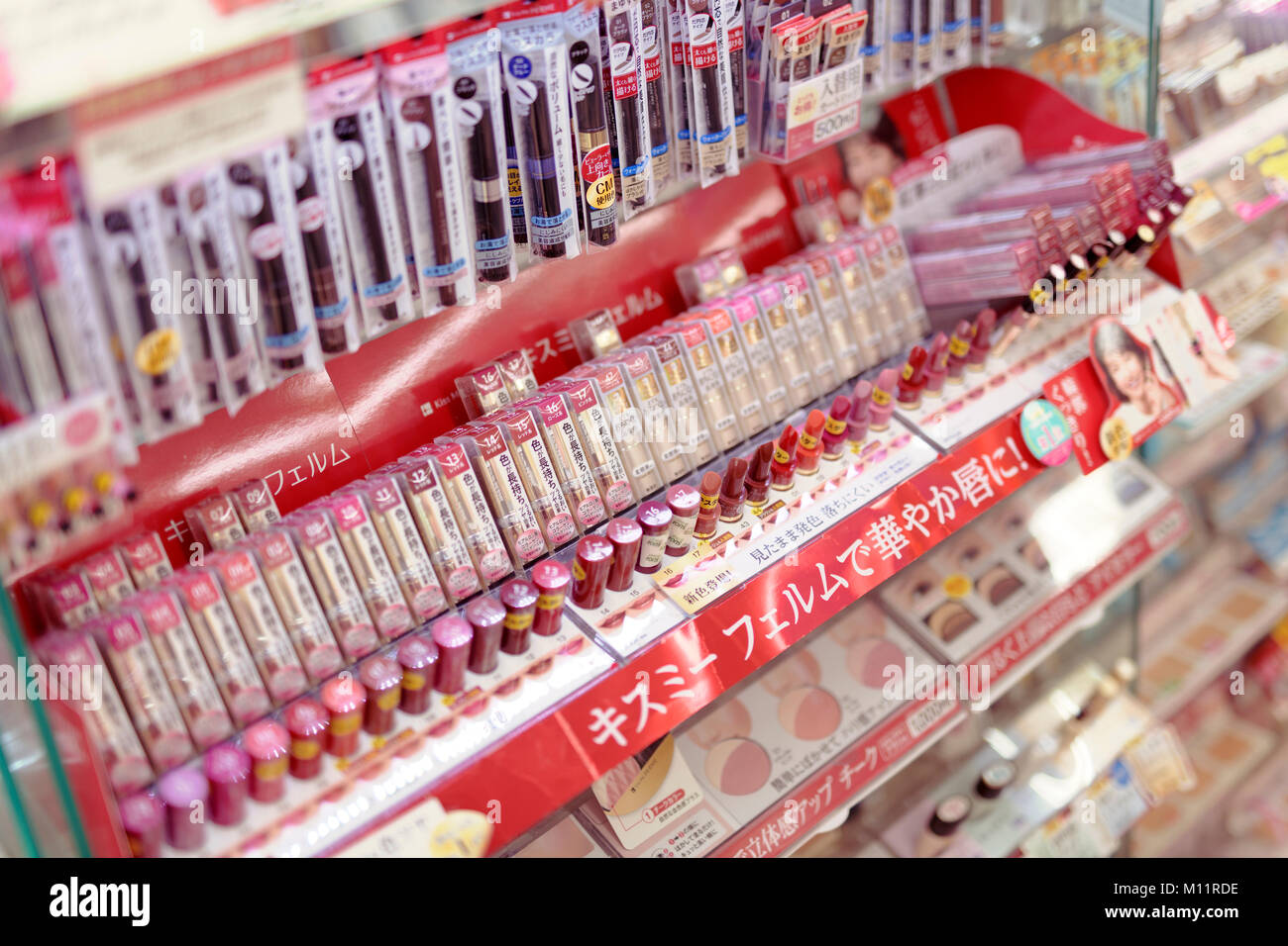 Shades of red and pink lipsticks in a Japanese makeup and beauty product store, lipstick testers
