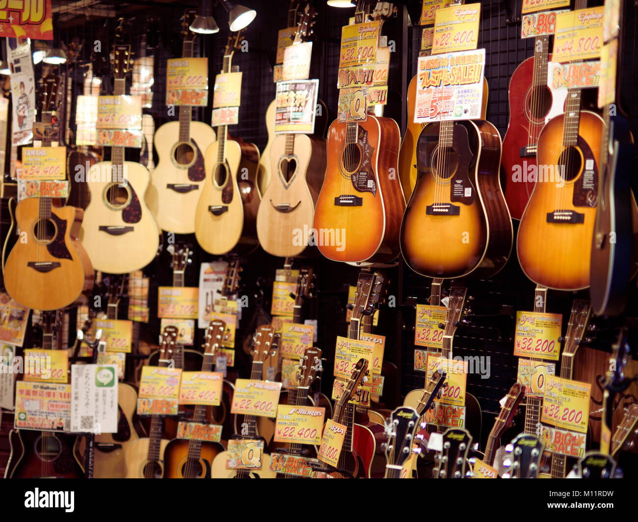 Acoustic guitars on display in a music instrument store in Kyoto, Japan 2017 Stock Photo