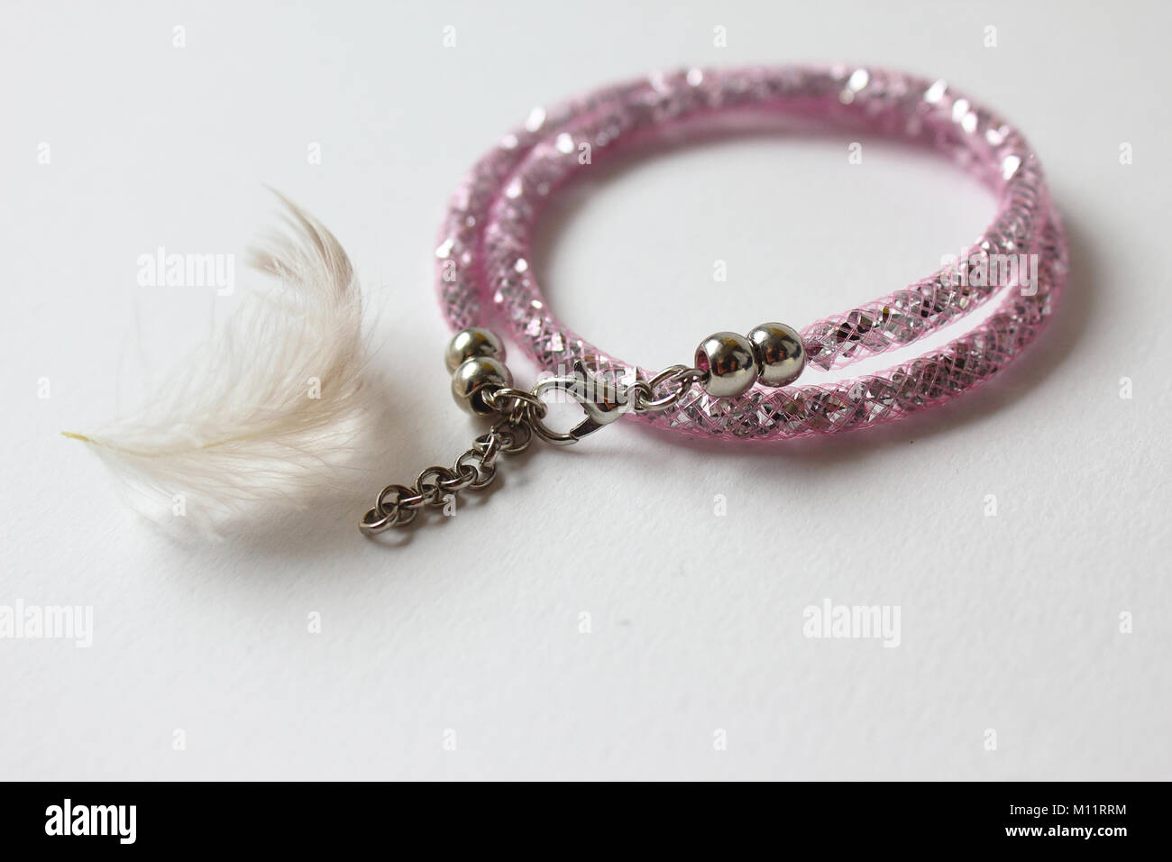 Pink bracelet with feather Stock Photo