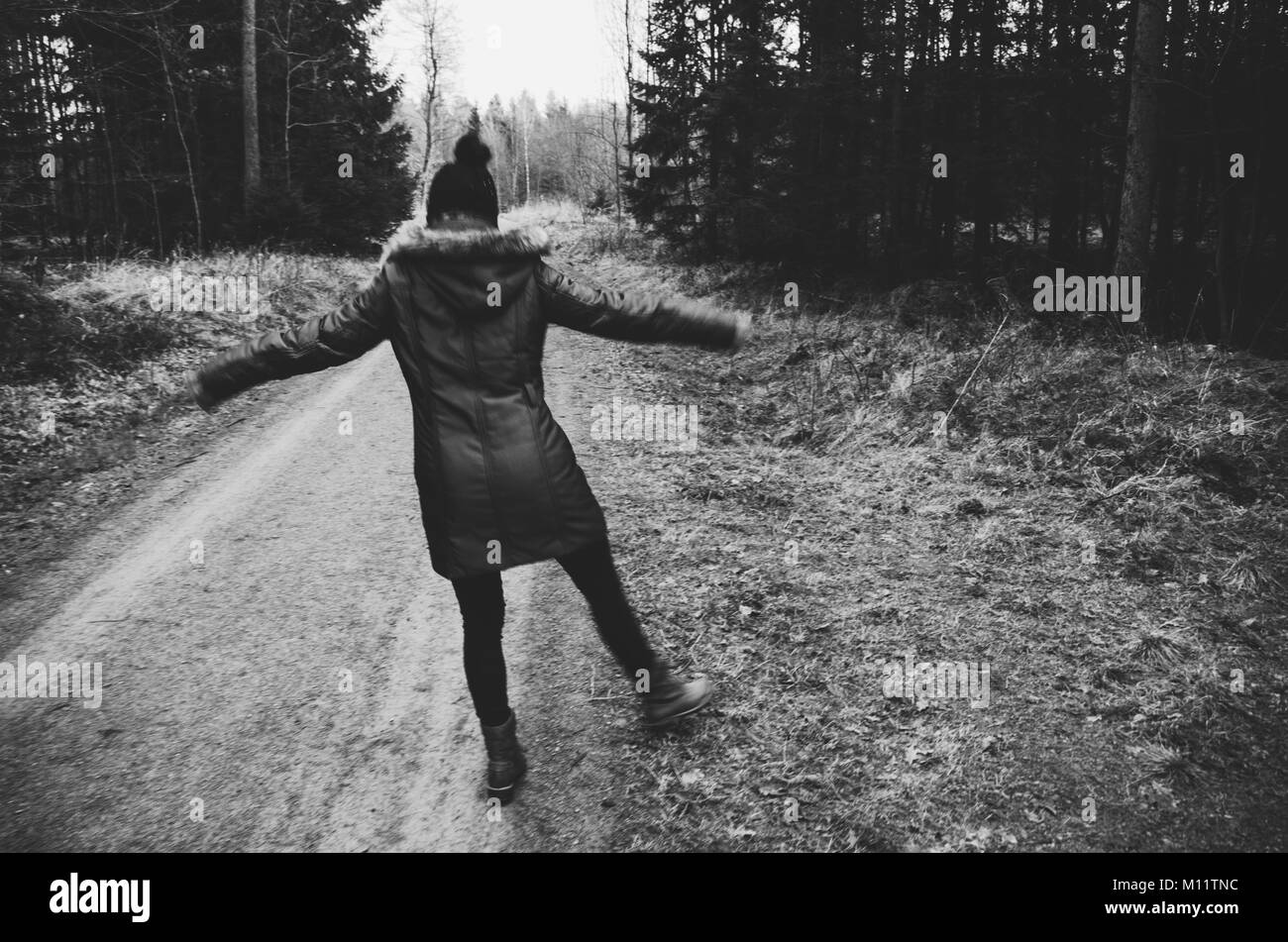 Woman enjoying walk in the forest - black and white Stock Photo