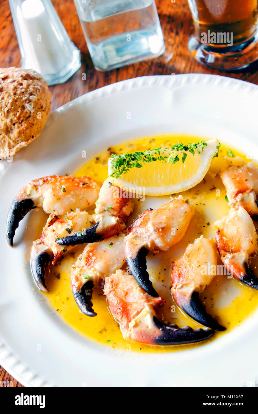 Crab claws sauteéd in garlic butter with lemon wedges, O'Dowd's Seafood Bar and Restaurant, Roundstone, Connemara, Galway, Ireland Stock Photo