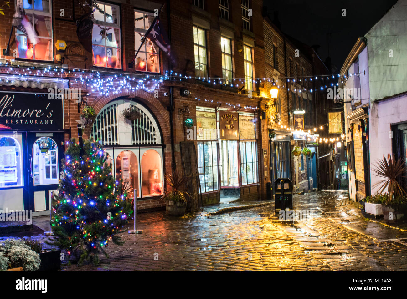 Wigan at Christmas. Very old fashioned scene here, looks great after being taken in the rain, reflects the light very well. Stock Photo
