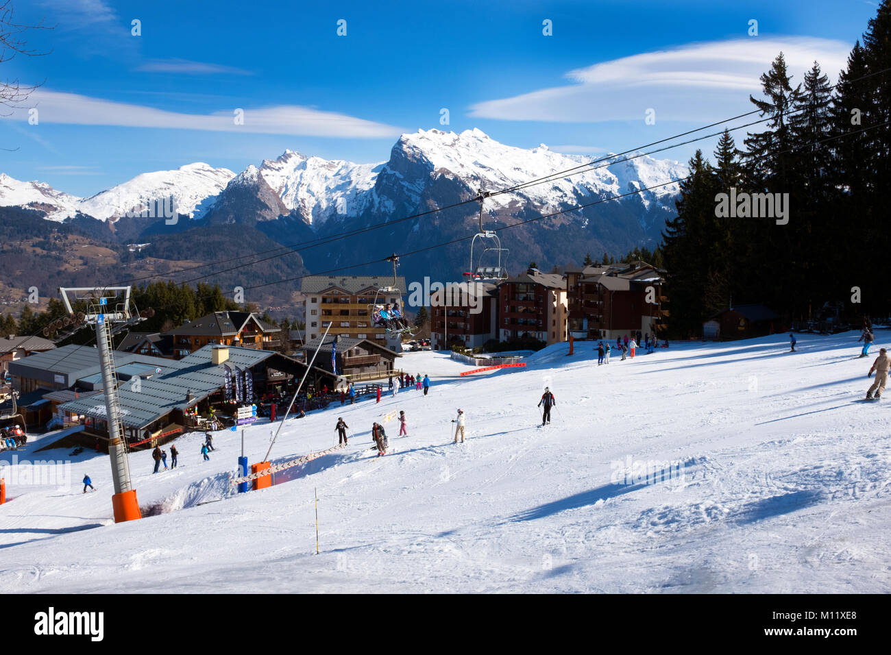View of Skiers from the chair lift on a Sunny ski piste Samoens France Stock Photo
