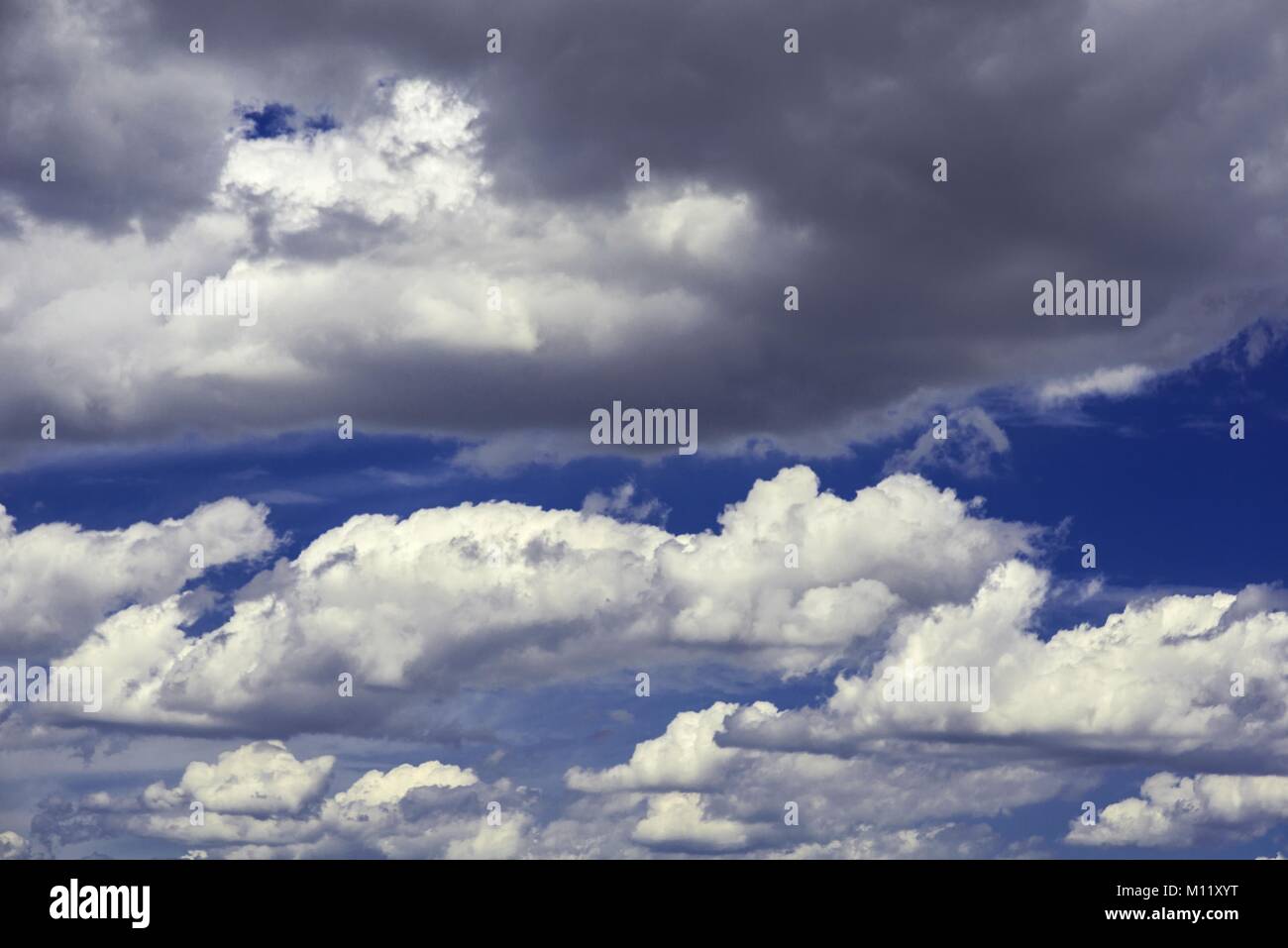 Blue sky with white and gray clouds Stock Photo - Alamy