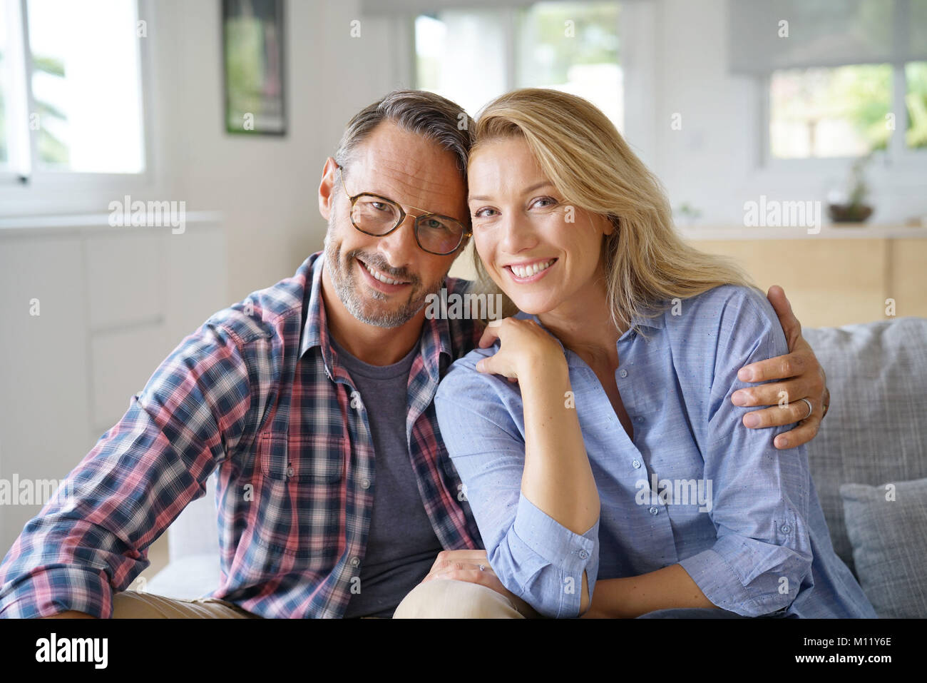 Portrait of mature couple relaxing at home Stock Photo - Alamy