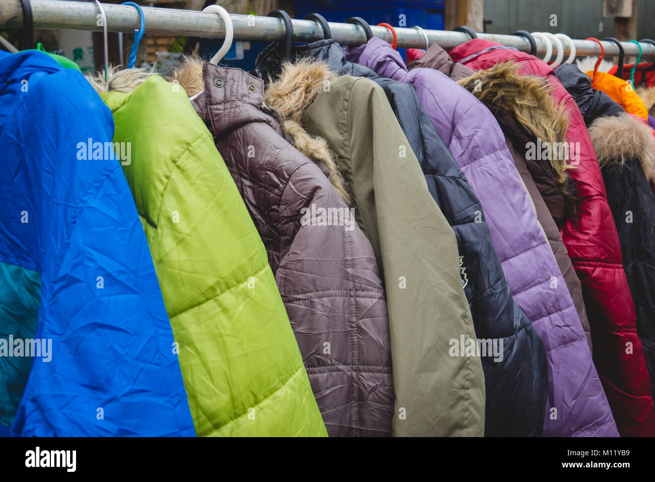 Fashion winter coats hanged on a clothes rack Stock Photo Alamy