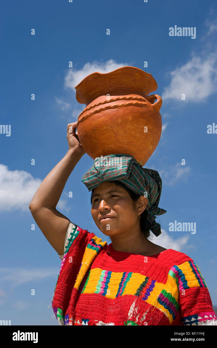 Mexico. Chiapas. Amatenango del Valle. Ethnic group of Tzeltal Indians. Woman carrying pottery on head. Stock Photo