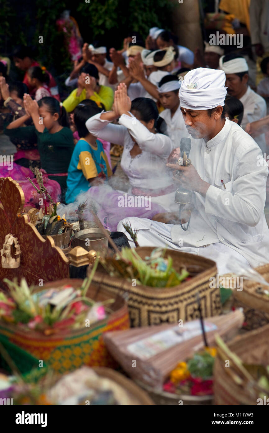 Indonesia, Island Bali, Tejakula village, Pura Maksan Temple. Hindu priest and people worshipping. Stock Photo