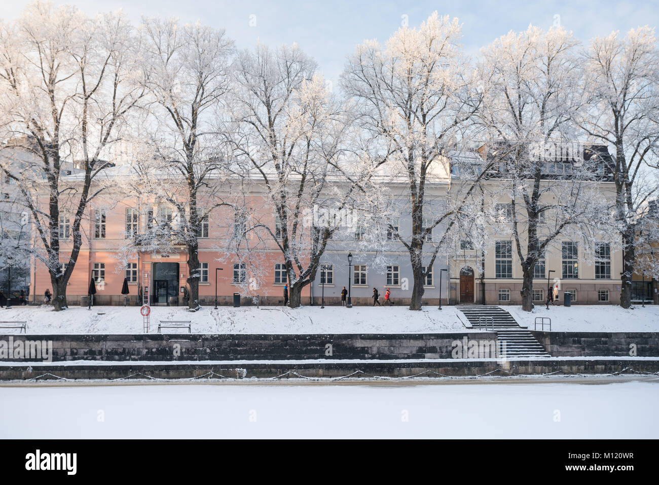 Front view of old colorful building in winter with beautiful frost covered trees on front in Turku, Finland Stock Photo