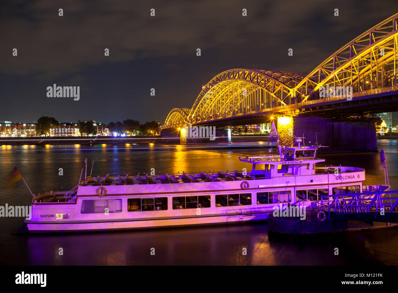 Germany, Cologne, the Hohenzollern bridge, excursion boat at a jetty, view across the river Rhine to the district Deutz.  Deutschland, Koeln, die Hohe Stock Photo