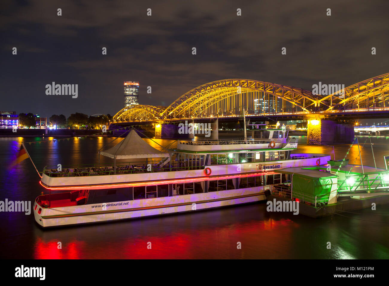 Germany, Cologne, Hohenzollern bridge and the CologneTriangle skyscraper of the Landschaftsverband Rheinland in the town district Deutz, excursion boa Stock Photo