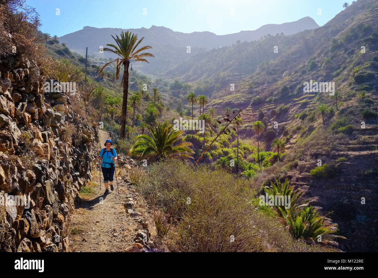 Woman hiking on trail in the Barranco de Simancas,near Vallehermoso,La Gomera,Canary Islands,Spain Stock Photo