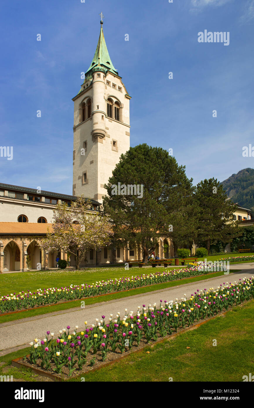 City park in spring,with flowering tulip beds,in the background bell tower of the parish church Maria Himmelfahrt,Schwaz Stock Photo