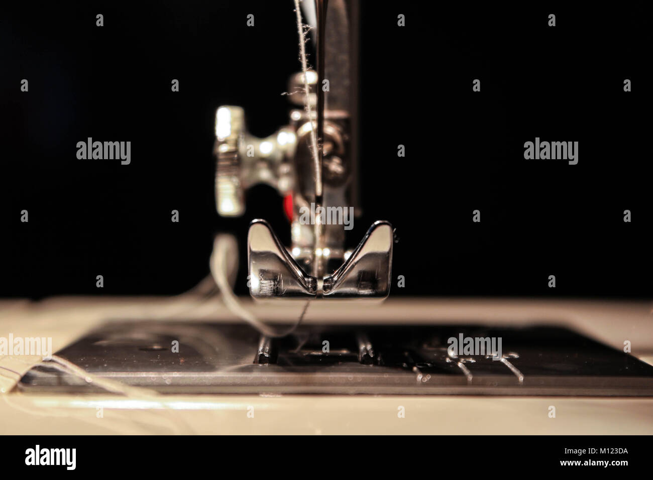 Sewing machine closeup, needle and string Stock Photo Alamy