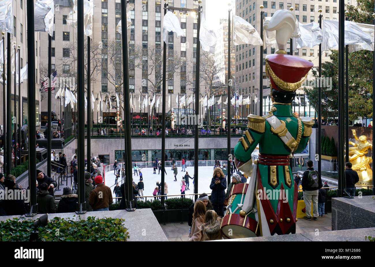 Christmas Holiday decorations at Rockefeller Center with the ice skating rink in the background.Manhattan.New York City.USA Stock Photo