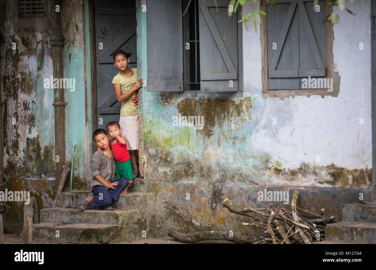 children at a door of their home in rural Bangladesh Stock Photo