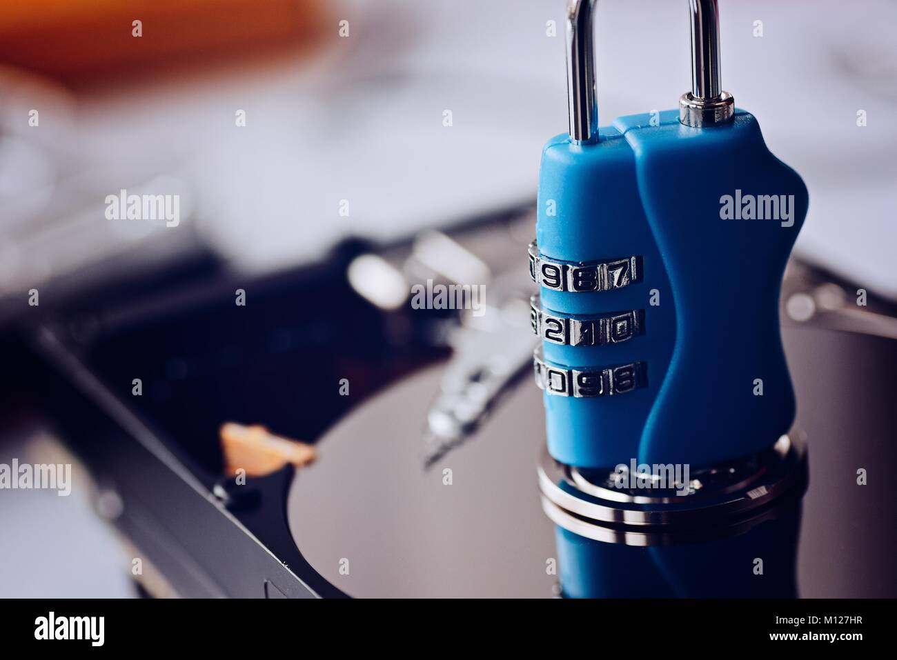 Encrypted hard disk. Padlock with cipher on an opened hard disk. Data ...