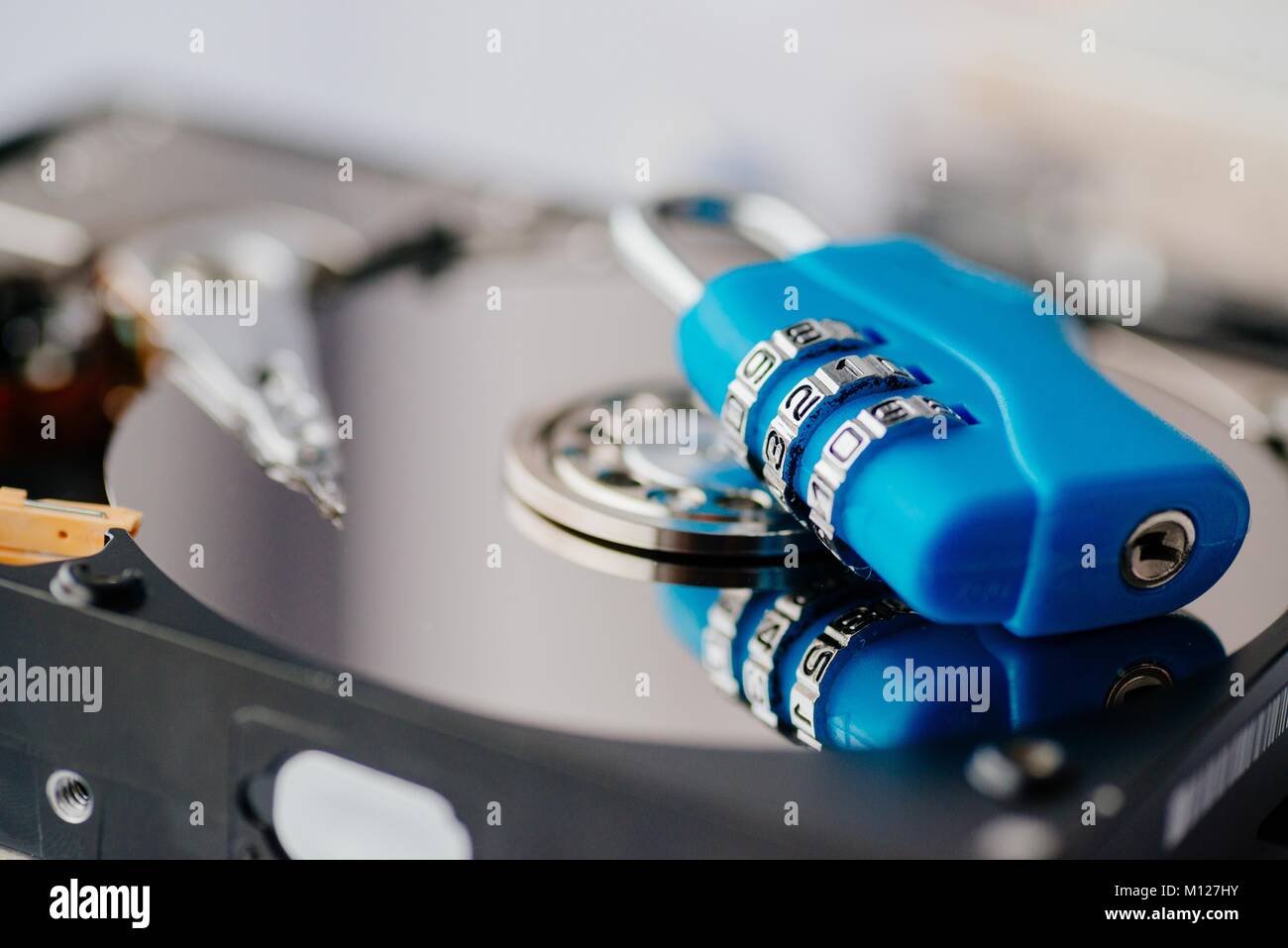 Encrypted hard disk. Padlock with cipher on an opened hard disk. Data ...
