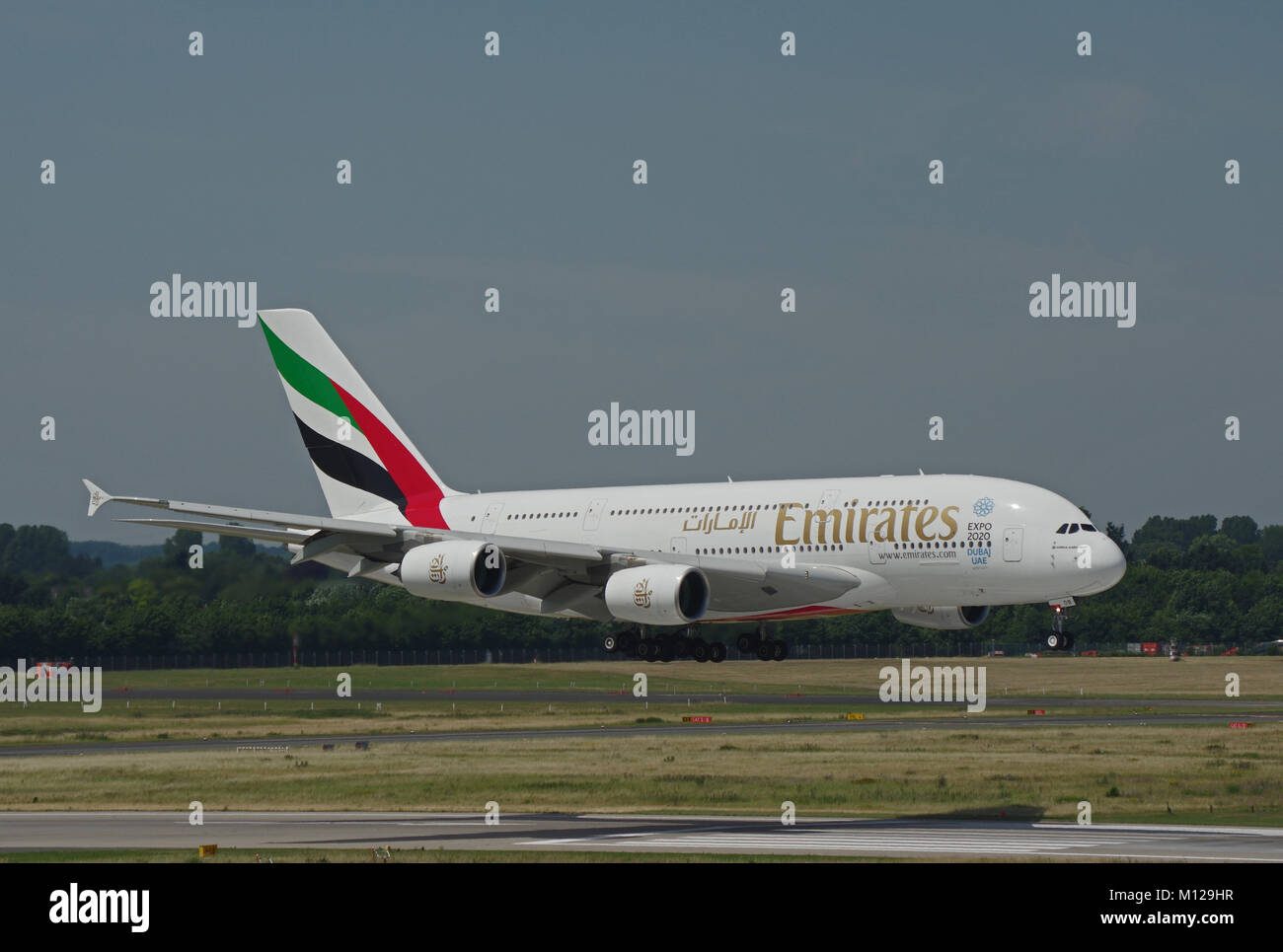 DUESSELDORF, GERMANY - JULY 1, 2015: Inaugural flight of Emirates Airline with Airbus A380-800 from Dubai to Duesseldorf while final approach Stock Photo