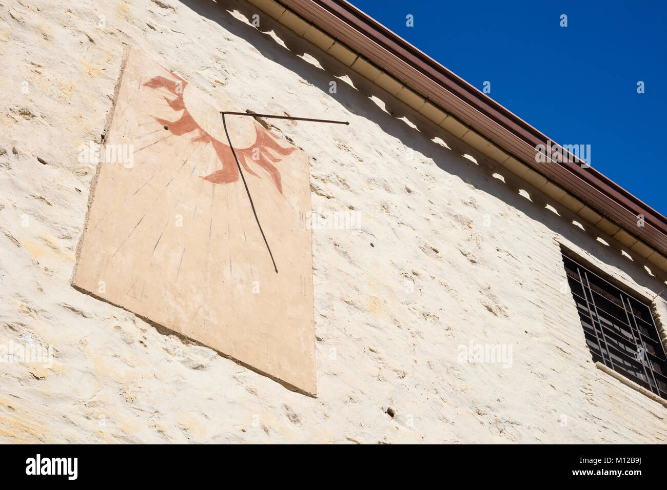 Detail of old sundial on a sunny day in a mediterranean country house in Catalonia, Spain. Stock Photo