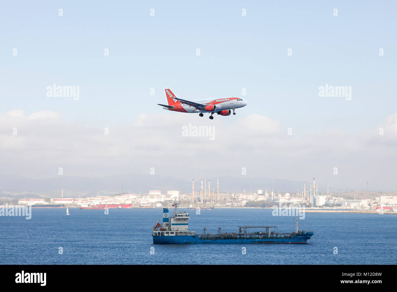 Jet plane on approach to landing at Gibraltar airport approaches over a ...