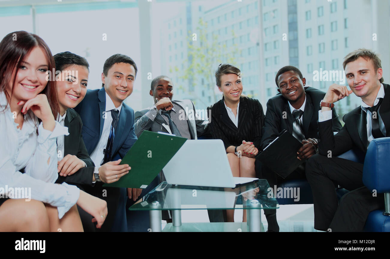Satisfied proud business team looking at camera and smiling in office ...