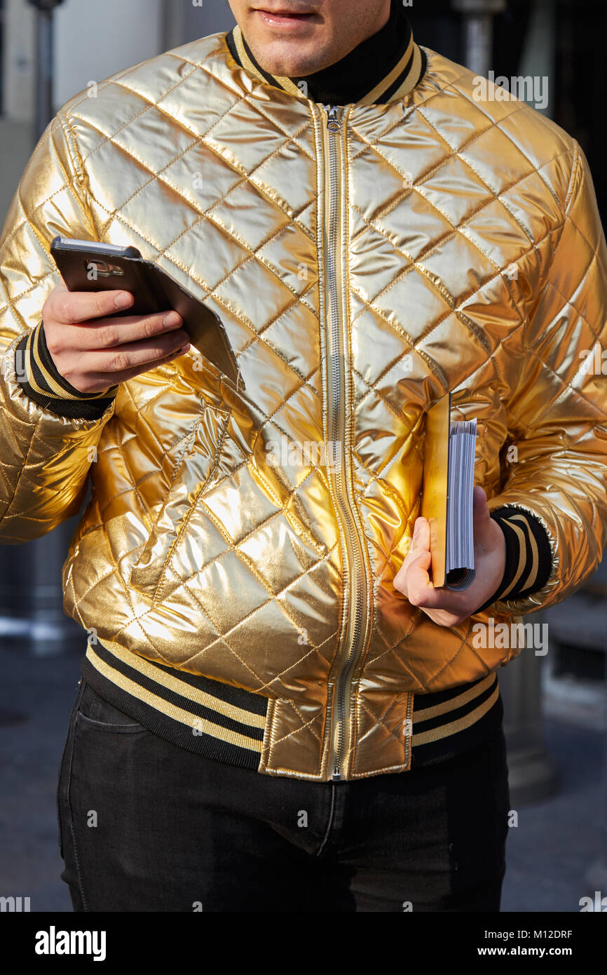 MILAN - JANUARY 14: Man with golden bomber jacket looking at smartphone  before Daks fashion show, Milan Fashion Week street style on January 14,  2018 Stock Photo - Alamy