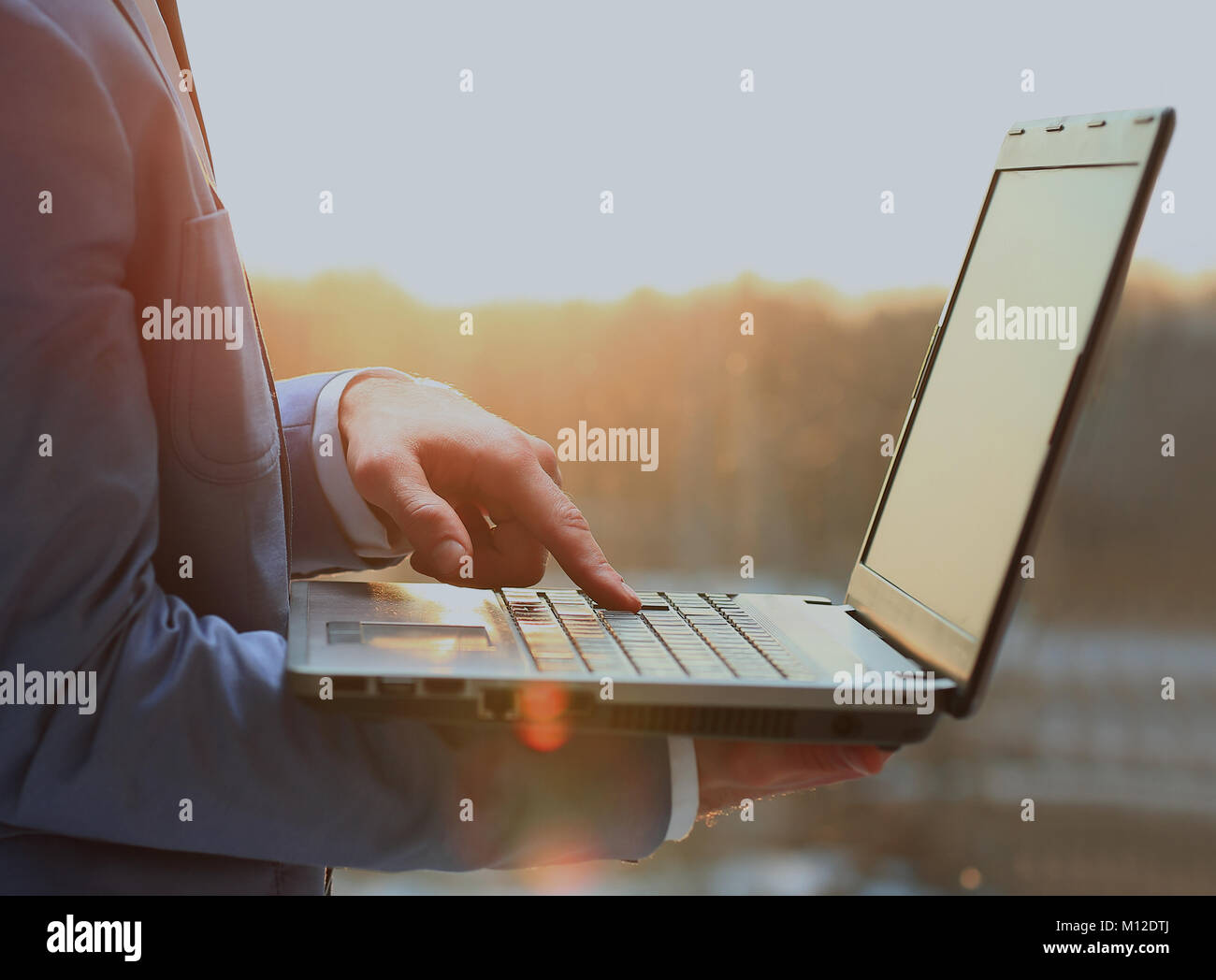 businessman working on a laptop in the office early in the morning ...