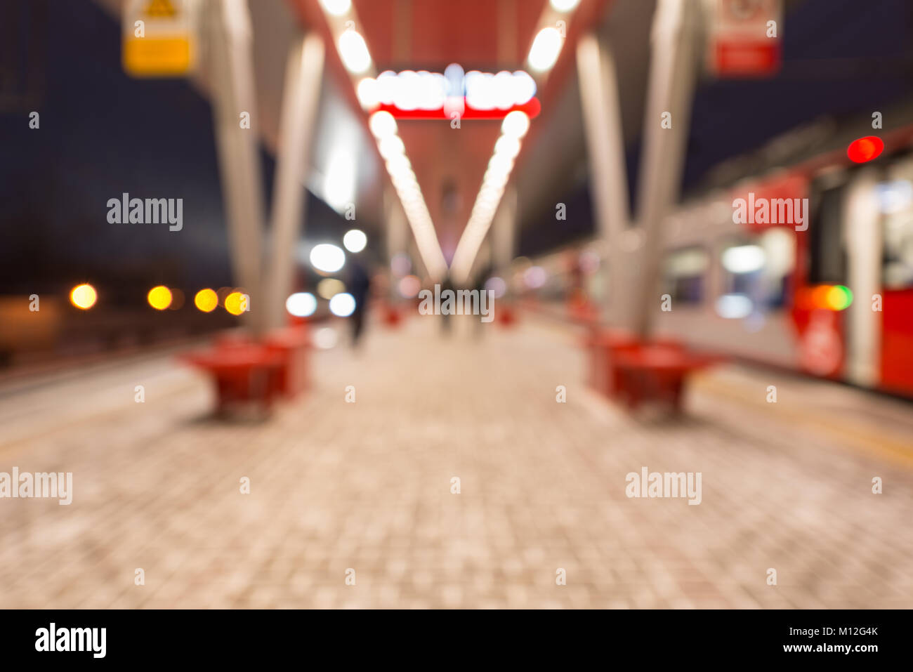 Blurred image of the highspeed trains by the station platform at evening time. Stock Photo