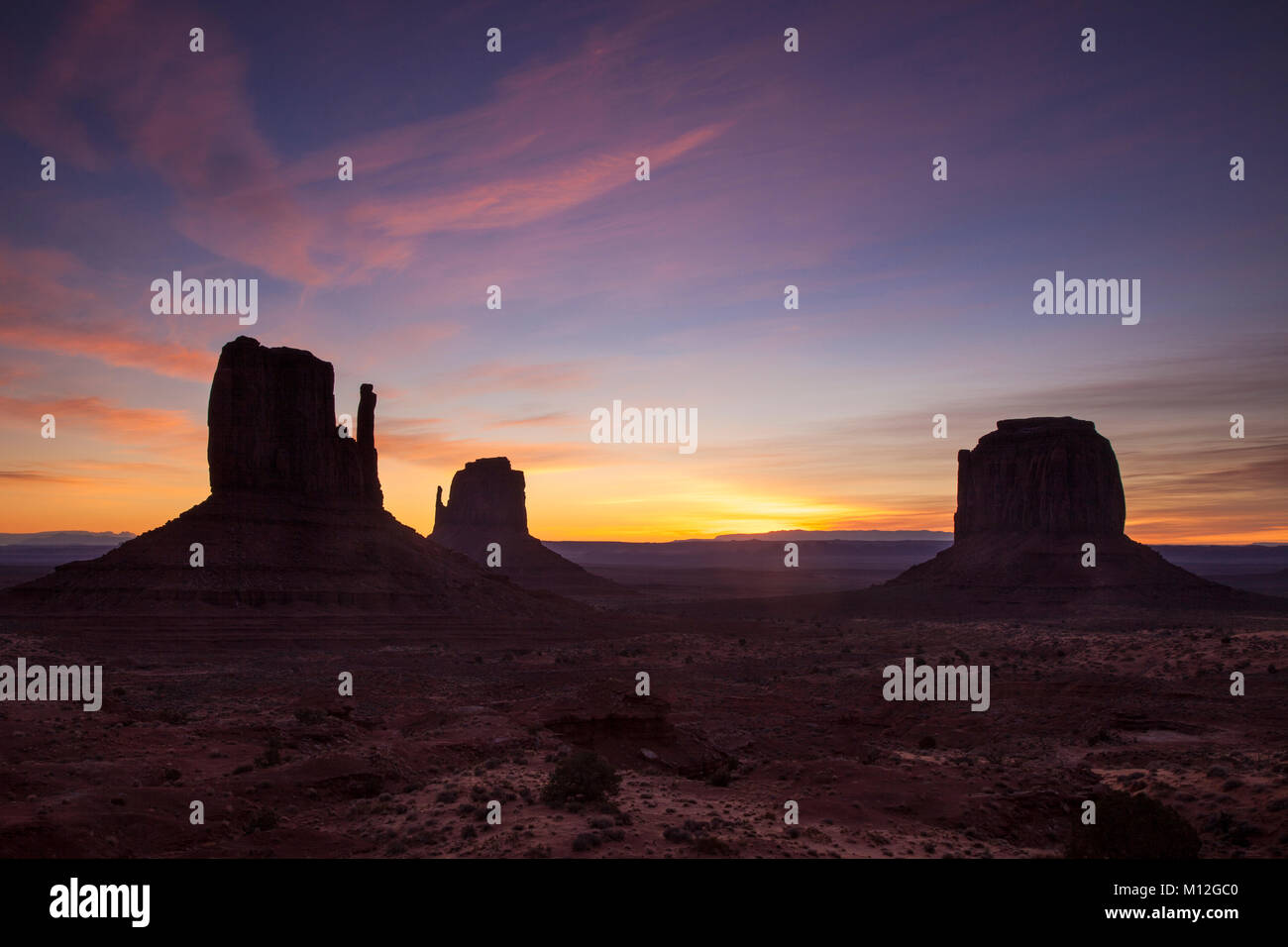 Sunrise over the Mittens rock formations in Monument Valley, Navajo Tribal Park, Arizona, USA Stock Photo