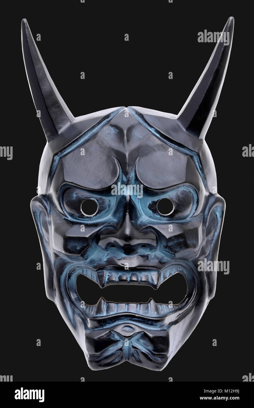 Traditional japanese demon mask used in Noh theater, black background